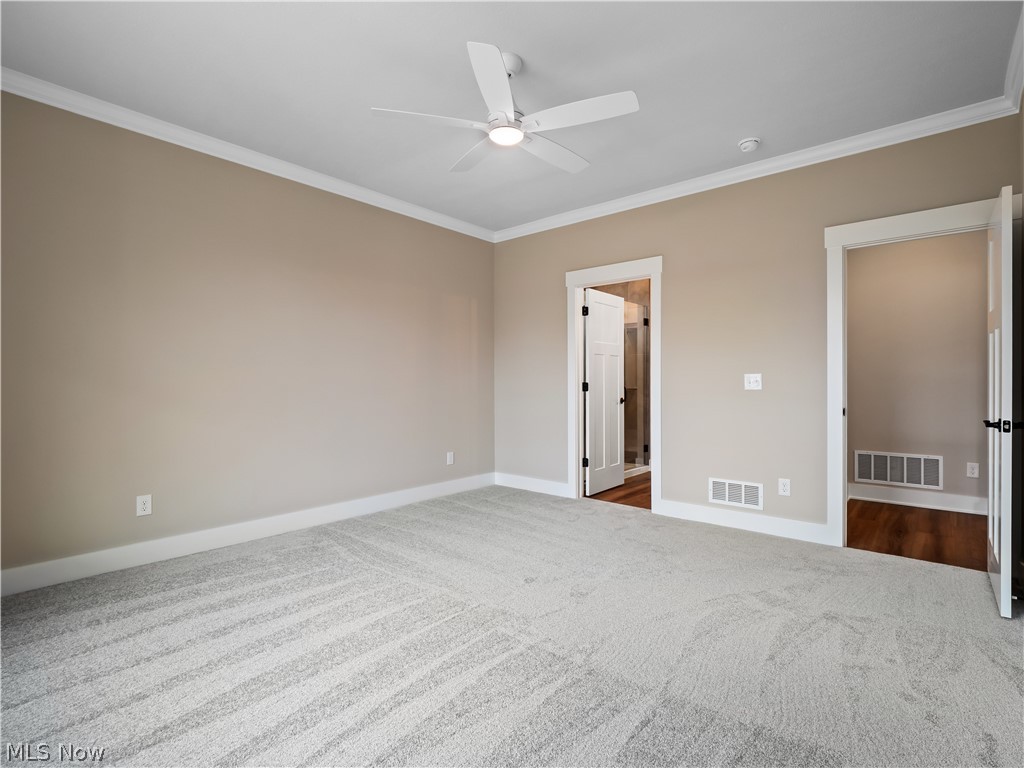 34270 Brookside Lane North Ridgeville, OH 44039 - Photo 26 of 50 Unfurnished bedroom with crown molding, carpet floors, ceiling fan, and connected bathroom