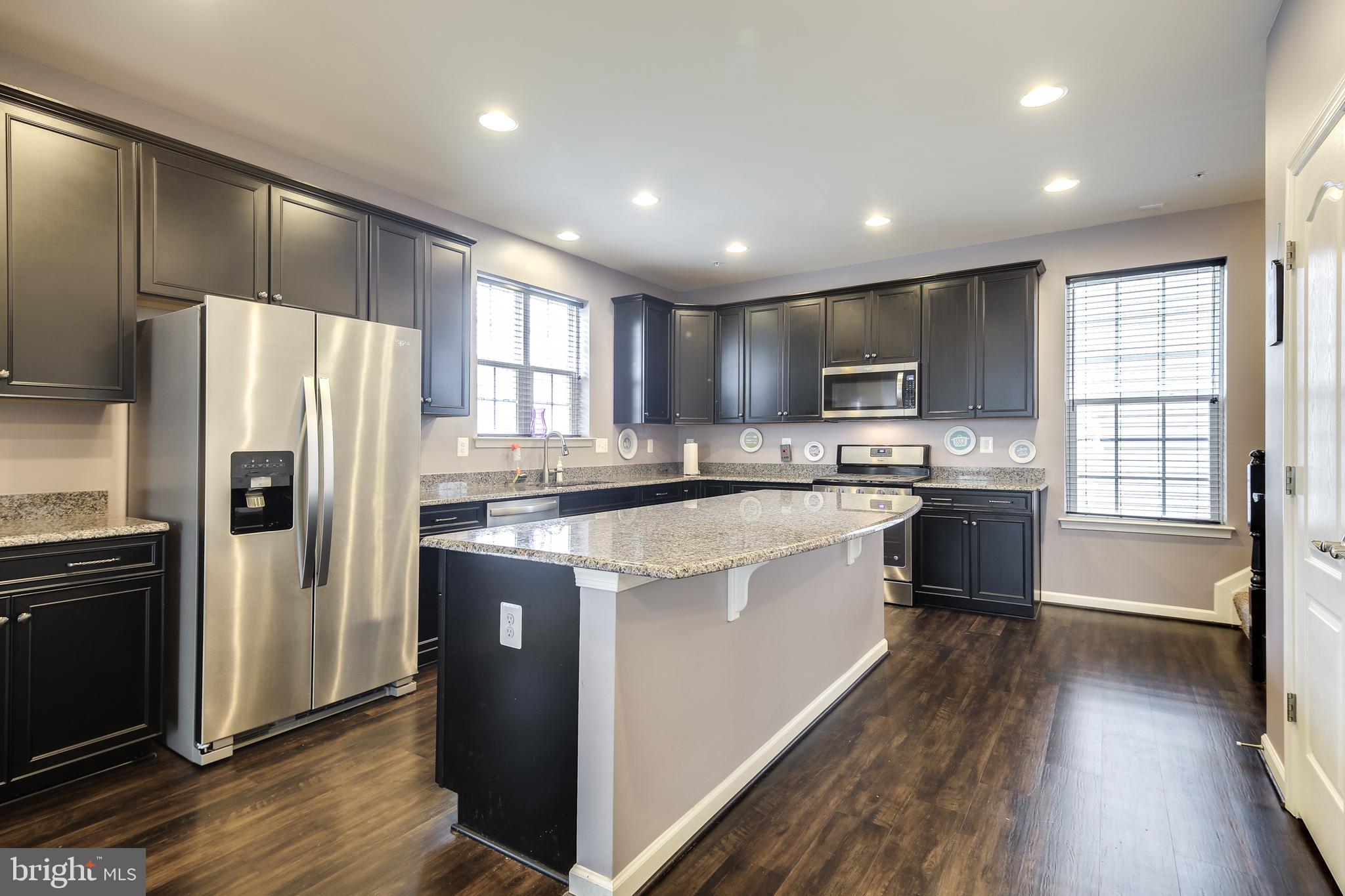 1008 Collier Run Road Baltimore, MD 21220 - Photo 3 of 33 a kitchen with stainless steel appliances granite countertop a refrigerator a sink dishwasher a stove and a refrigerator with wooden floor