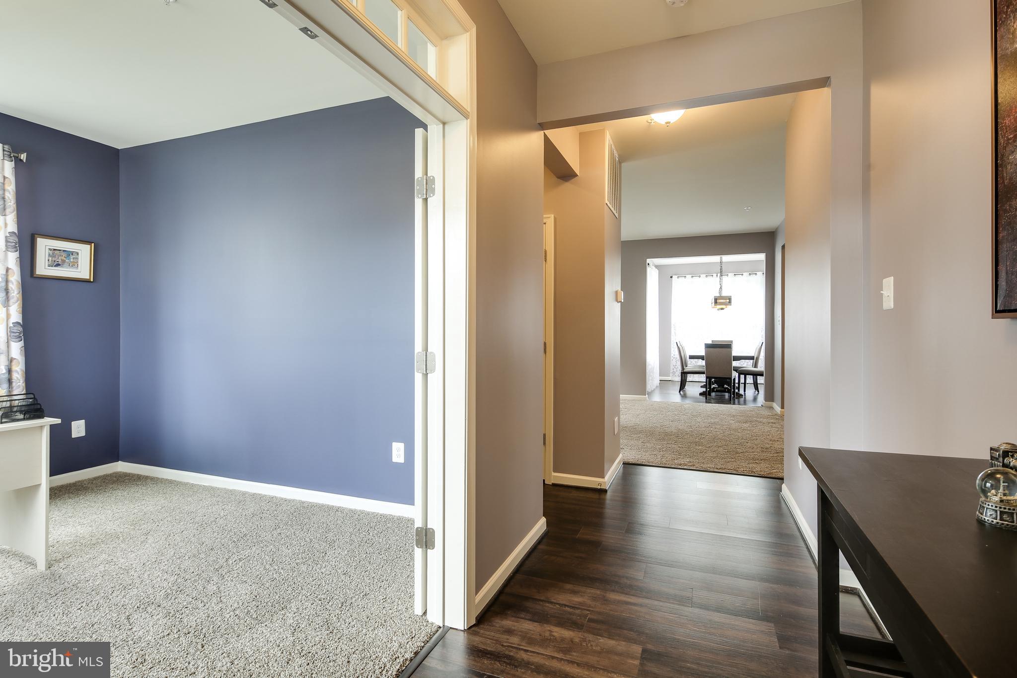 1008 Collier Run Road Baltimore, MD 21220 - Photo 5 of 33 a view of a hallway with wooden floor and a living room