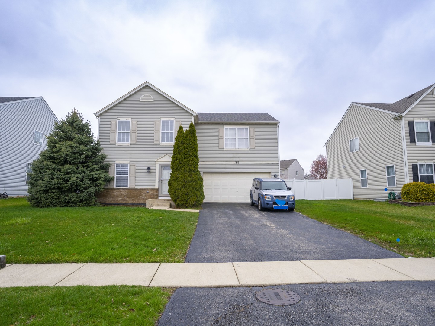 a view of a house with a yard and a fire pit