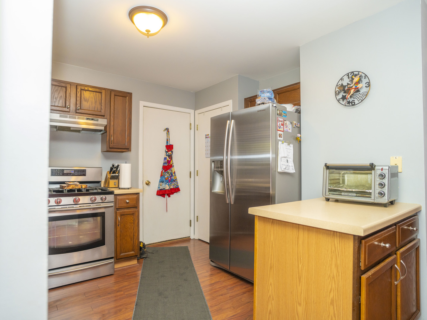 1717 Caton Ridge Drive Plainfield, IL 60586 - Photo 22 of 44 a kitchen with stainless steel appliances a stove a refrigerator and a sink