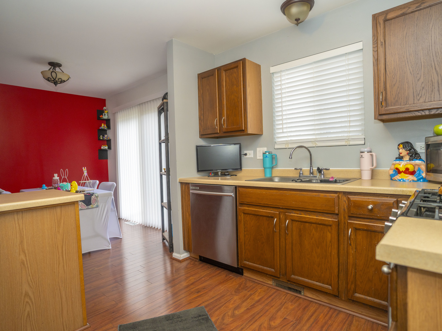 1717 Caton Ridge Drive Plainfield, IL 60586 - Photo 23 of 44 a kitchen with a sink cabinets and wooden floor