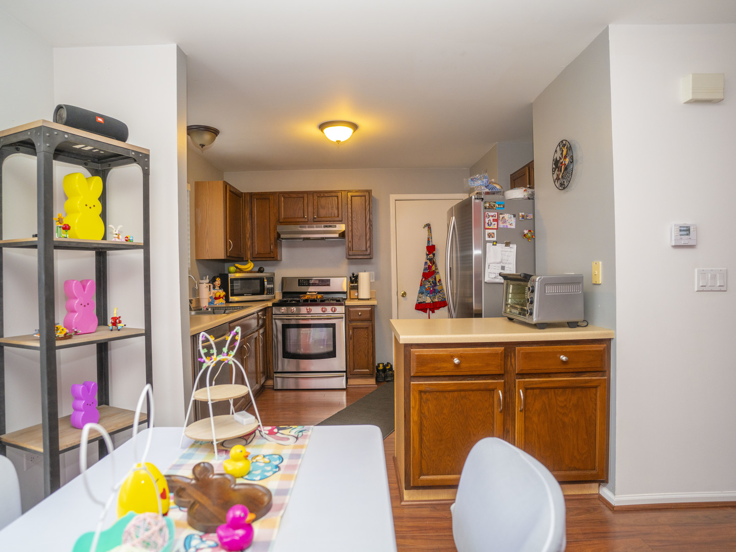 1717 Caton Ridge Drive Plainfield, IL 60586 - Photo 25 of 44 a kitchen with stainless steel appliances a stove a refrigerator and a dining table