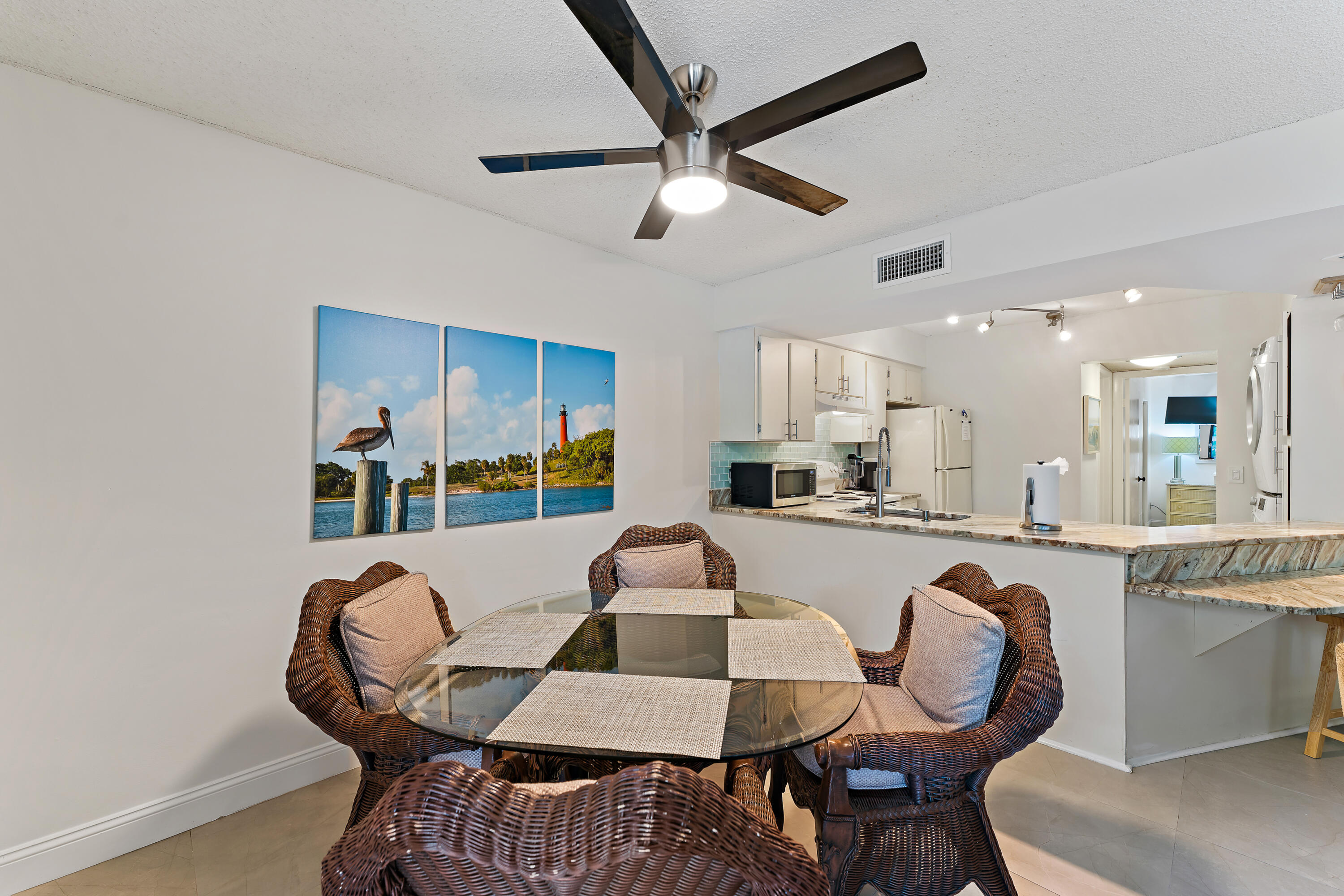 1605 Highway 1, Unit E104 Jupiter, FL 33477 - Photo 16 of 34 a dining room with furniture and window