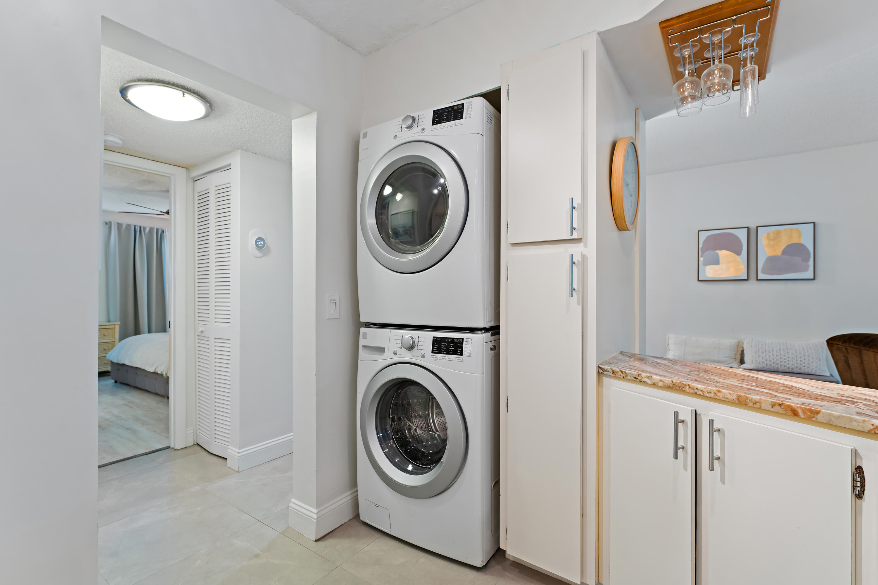1605 Highway 1, Unit E104 Jupiter, FL 33477 - Photo 22 of 34 a utility room with dryer and washer