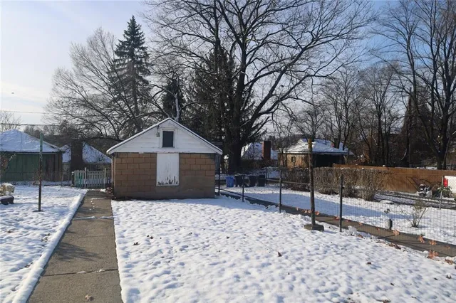 a house covered with snow in front of house