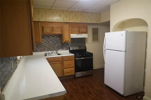 a kitchen with a refrigerator and a stove