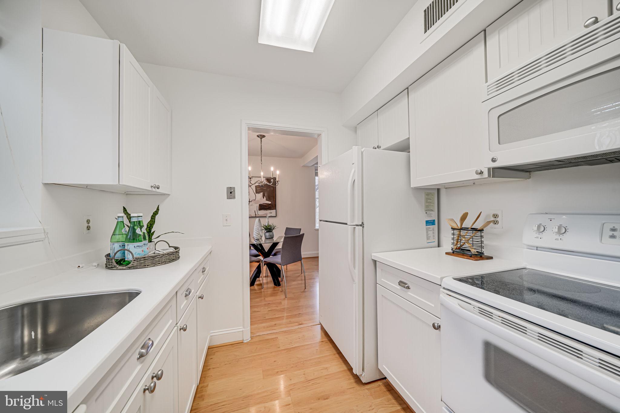 3701 39th Street Northwest, Unit A181 Washington, DC 20016 - Photo 13 of 68 a kitchen with white cabinets and appliances
