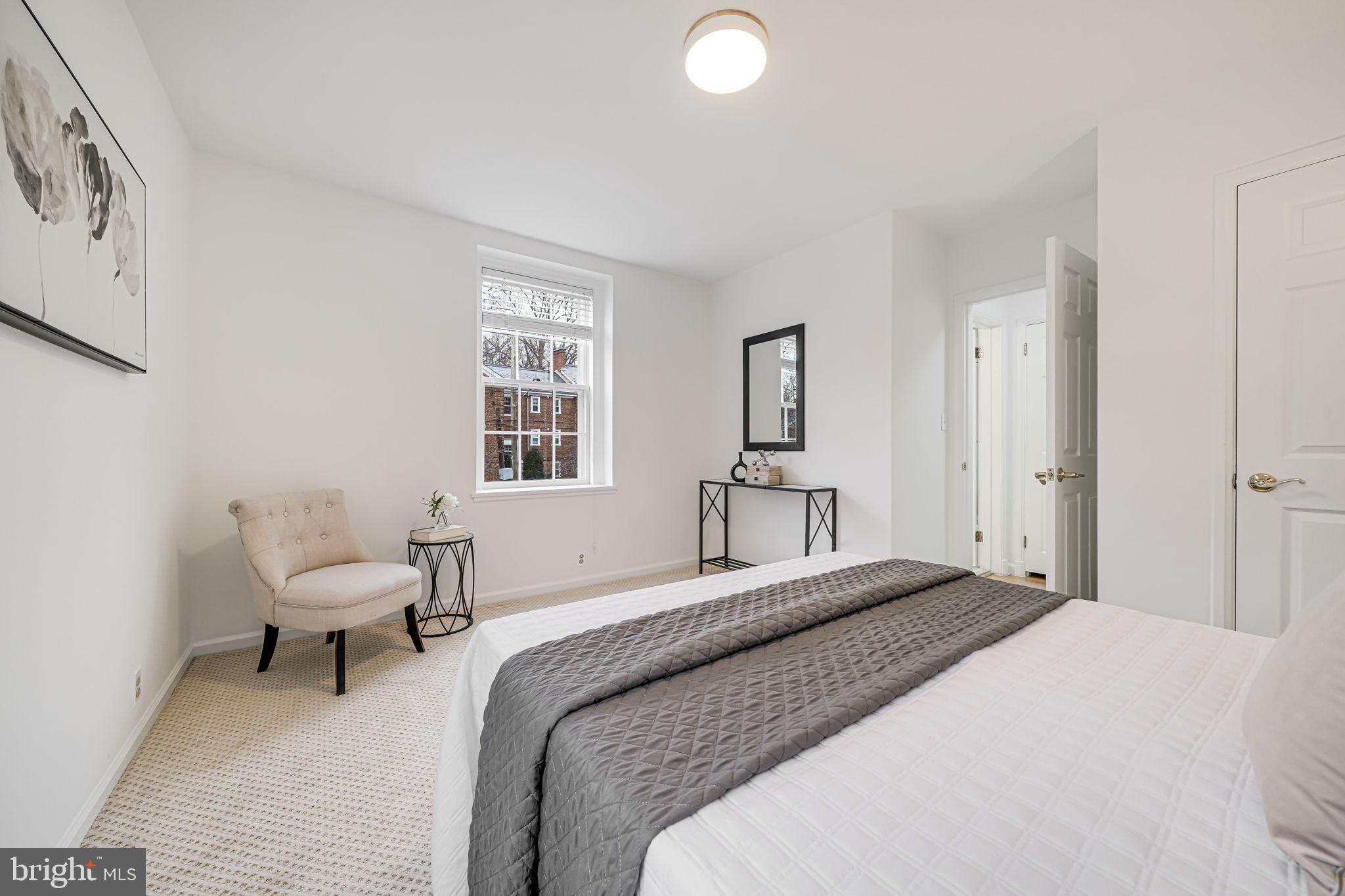 3701 39th Street Northwest, Unit A181 Washington, DC 20016 - Photo 18 of 68 a bedroom with a bed and chair