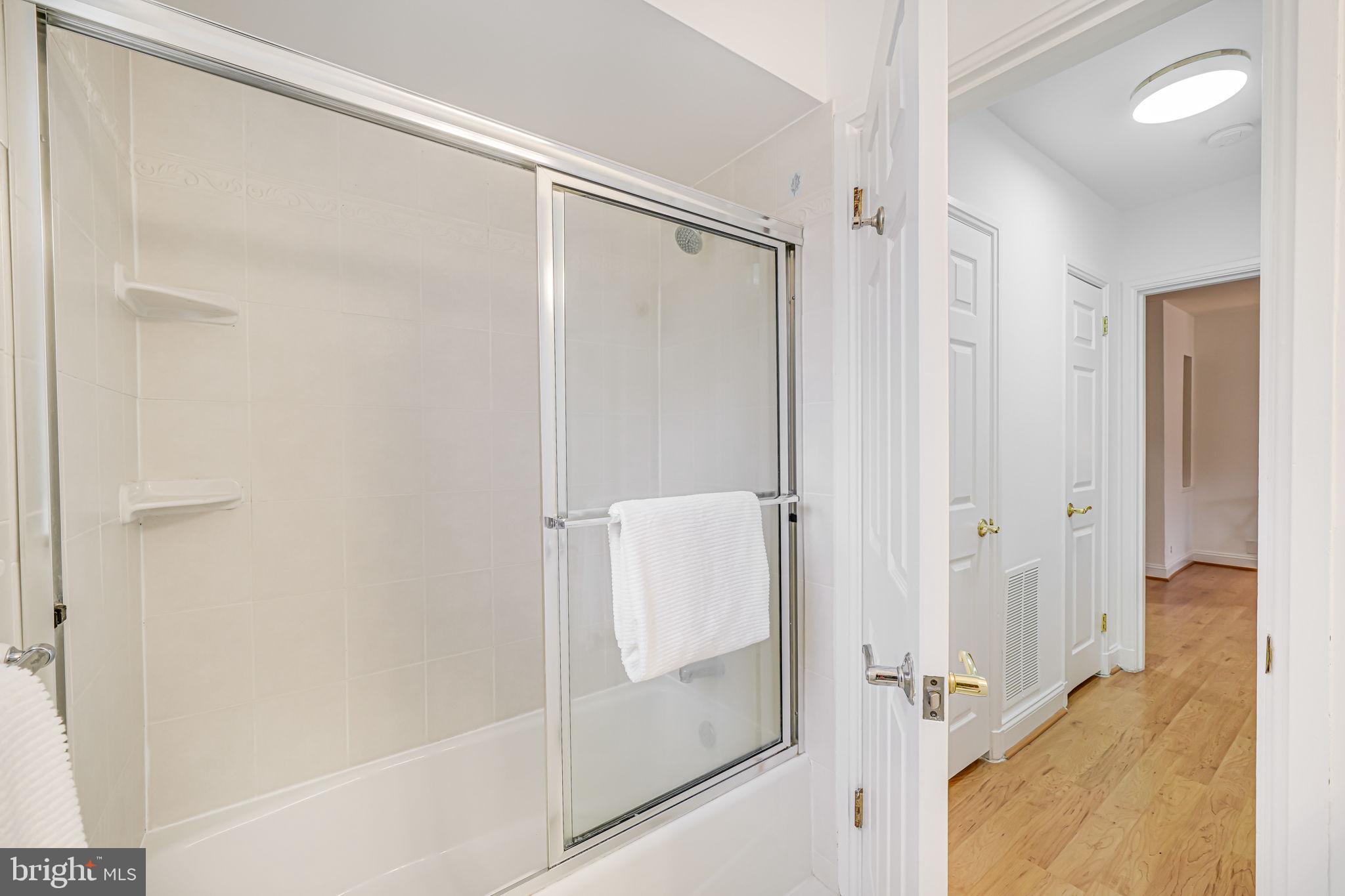 3701 39th Street Northwest, Unit A181 Washington, DC 20016 - Photo 20 of 68 a bathroom with a glass shower door