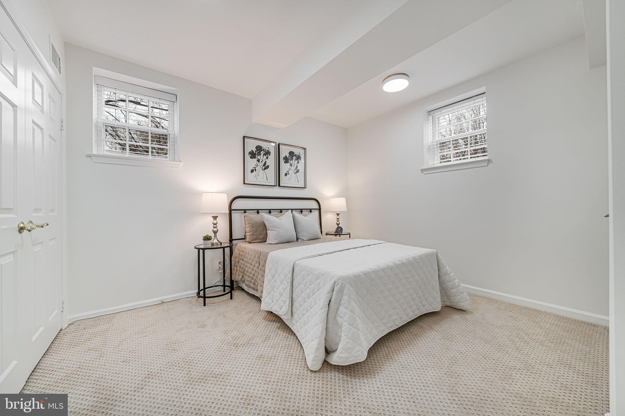 3701 39th Street Northwest, Unit A181 Washington, DC 20016 - Photo 31 of 68 a bedroom with a bed and a wall painting
