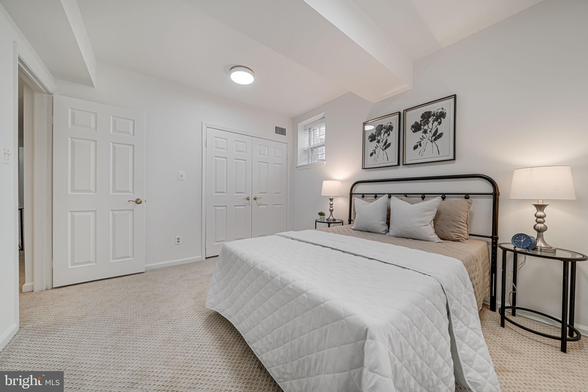 3701 39th Street Northwest, Unit A181 Washington, DC 20016 - Photo 33 of 68 a bedroom with a bed and painting on the wall