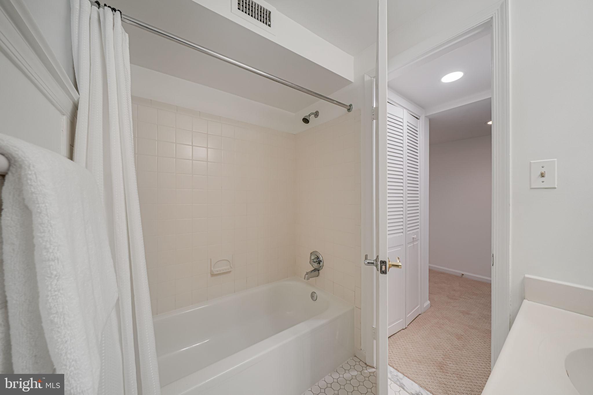 3701 39th Street Northwest, Unit A181 Washington, DC 20016 - Photo 35 of 68 a bathroom with a bathtub and shower