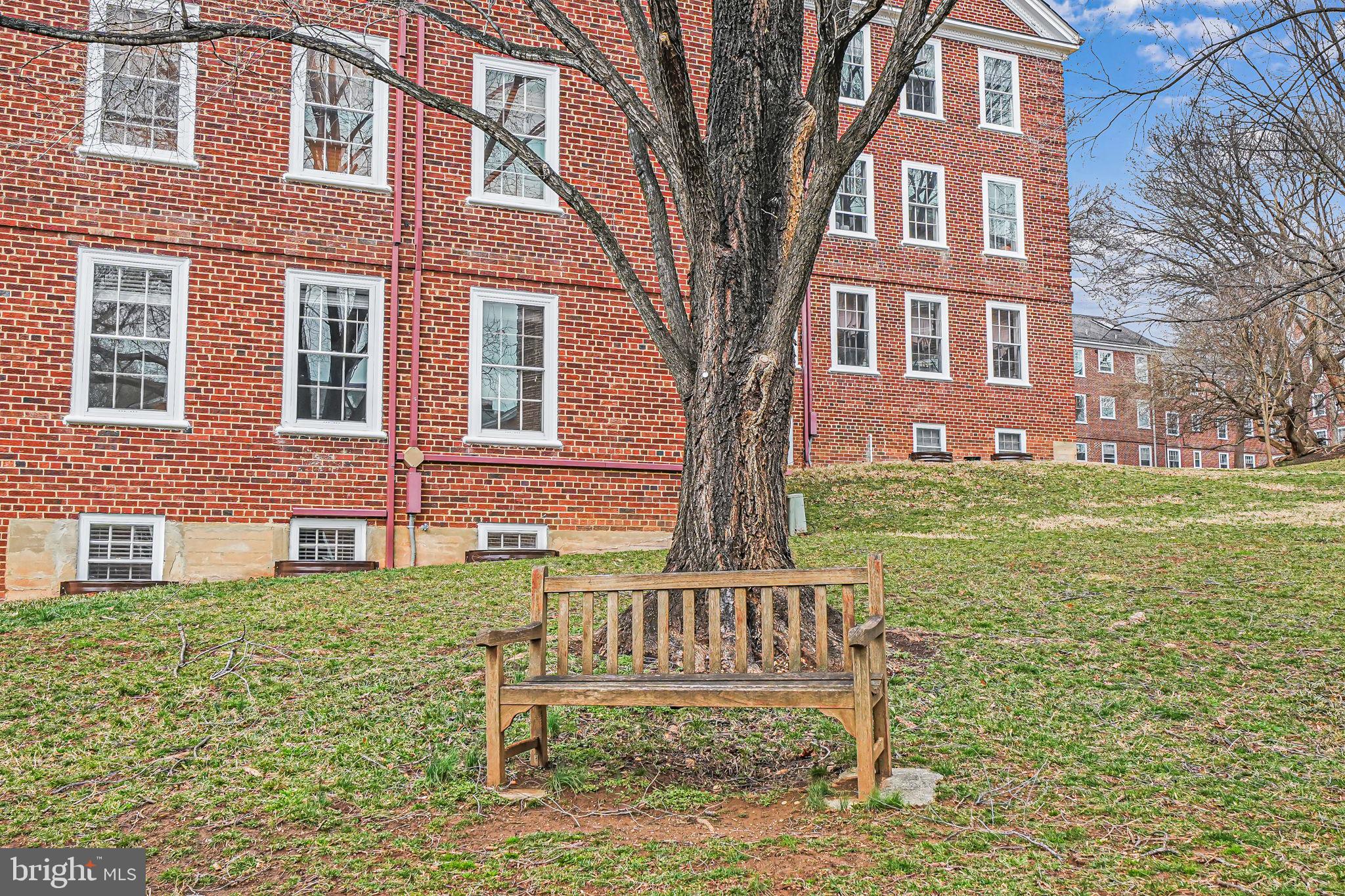 3701 39th Street Northwest, Unit A181 Washington, DC 20016 - Photo 40 of 68 a view of a brick building next to a yard