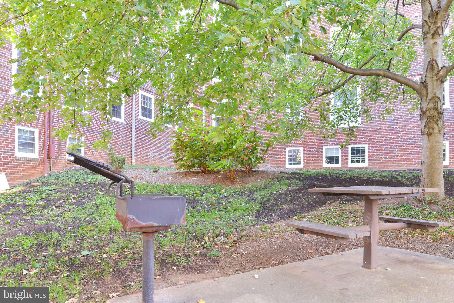 3701 39th Street Northwest, Unit A181 Washington, DC 20016 - Photo 41 of 68 a front view of a house with a yard