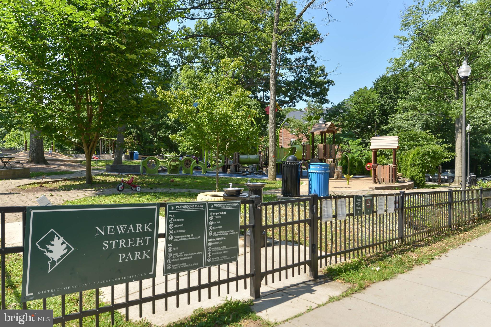 3701 39th Street Northwest, Unit A181 Washington, DC 20016 - Photo 50 of 68 a view of a street sign under a large tree