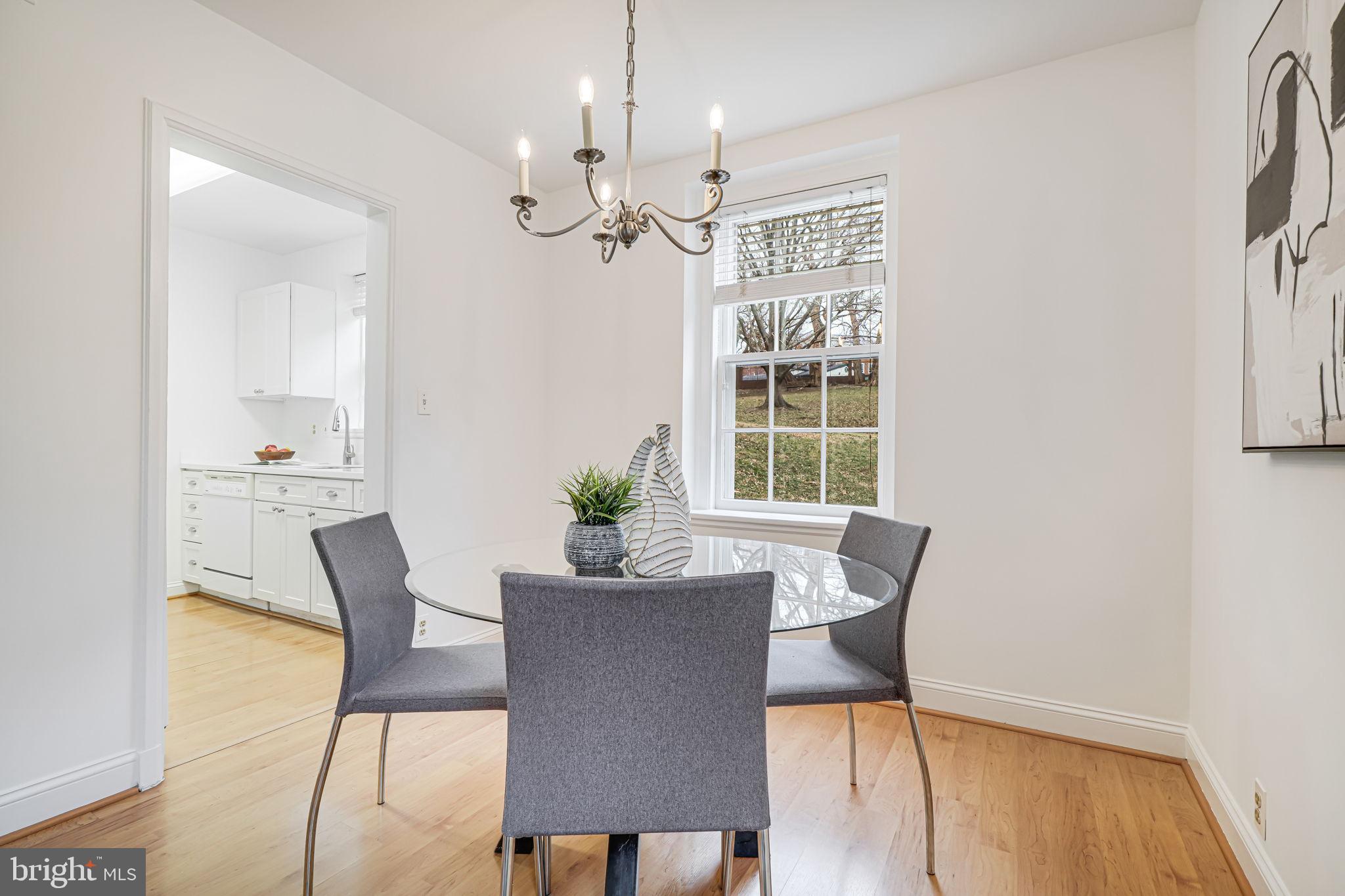 3701 39th Street Northwest, Unit A181 Washington, DC 20016 - Photo 8 of 68 a view of a dining room with furniture a chandelier and wooden floor