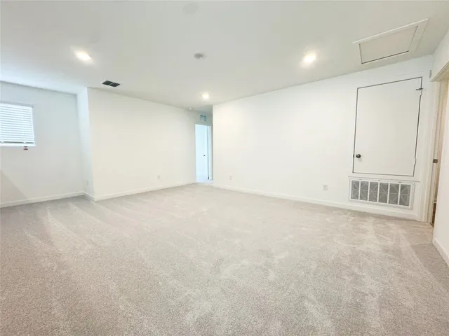 a bedroom with a bed and painting on the wall