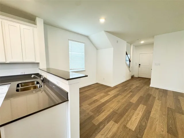 a kitchen with stainless steel appliances a refrigerator sink and microwave