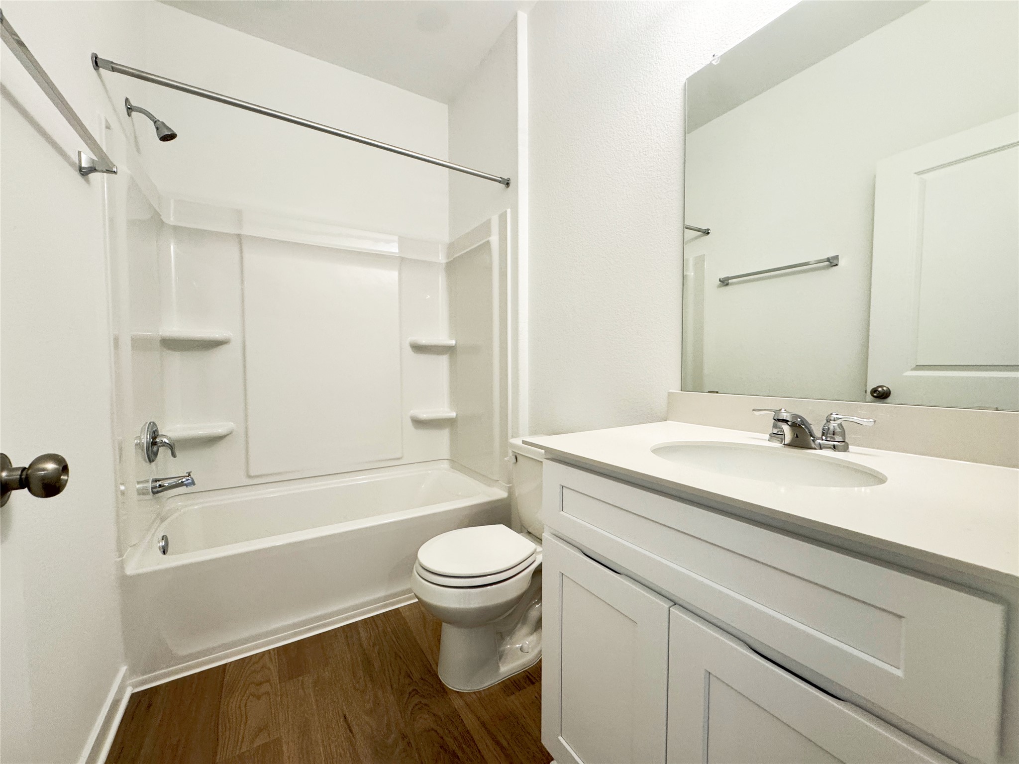 130 Golden Bell Way Buda, TX 78610 - Photo 8 of 34 Full bathroom featuring bathing tub / shower combination, vanity, and dark wood-type flooring