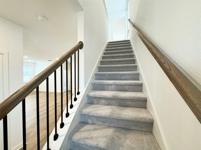 a dining room with furniture a chandelier and wooden floor