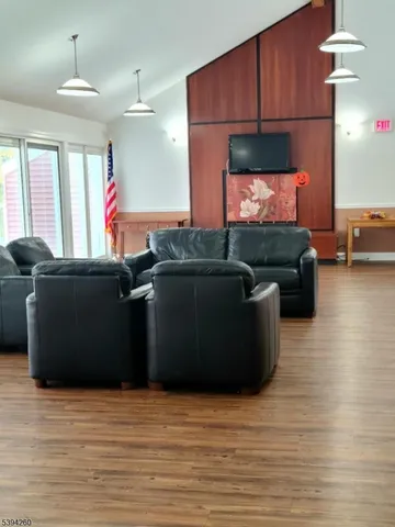 a view of a livingroom with furniture wooden floor and a window
