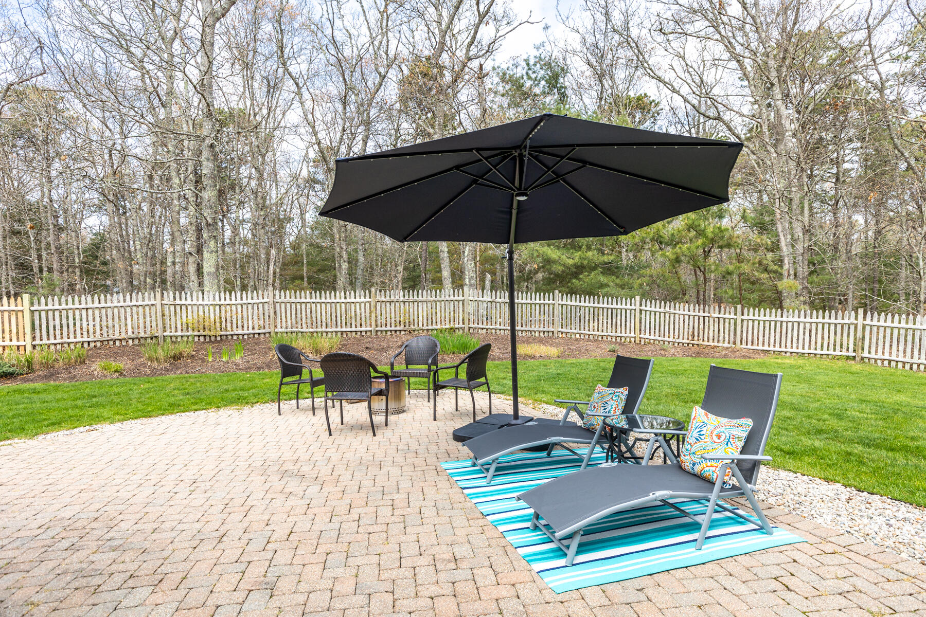 25 Peach Tree Road Marstons Mills, MA 02648 - Photo 25 of 33 a view of a table and chairs under an umbrella