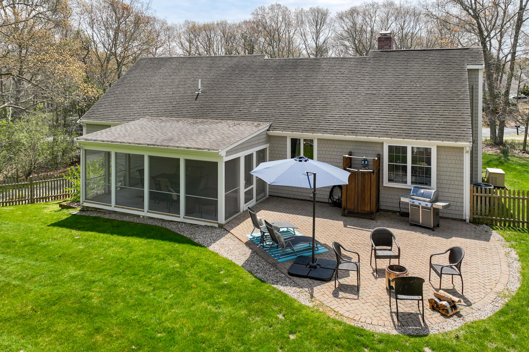 25 Peach Tree Road Marstons Mills, MA 02648 - Photo 30 of 33 a front view of a house with a yard glass top table and chairs
