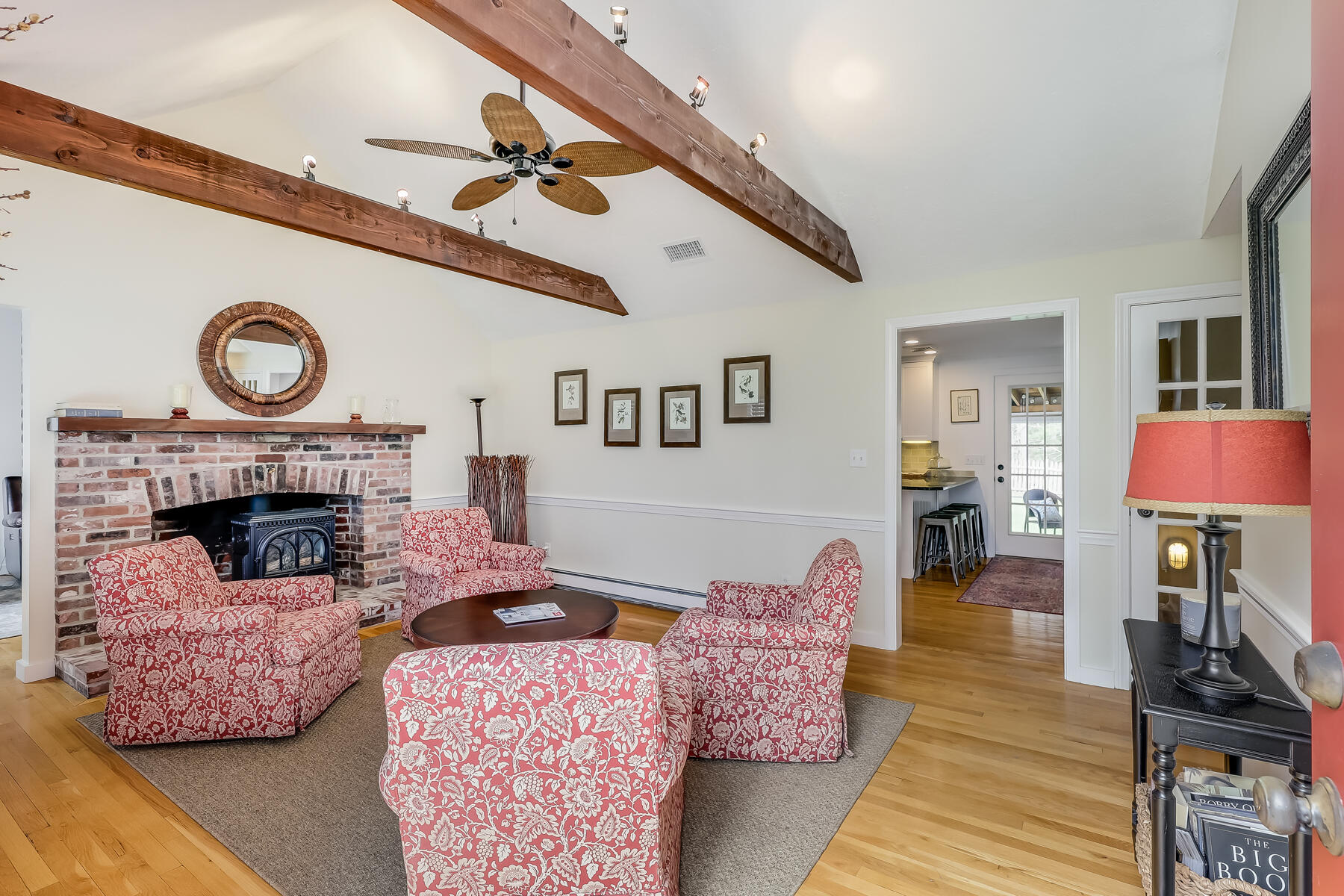 25 Peach Tree Road Marstons Mills, MA 02648 - Photo 9 of 33 a living room with furniture a flat screen tv and a fireplace