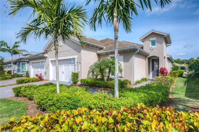 front view of house with a yard and potted plants