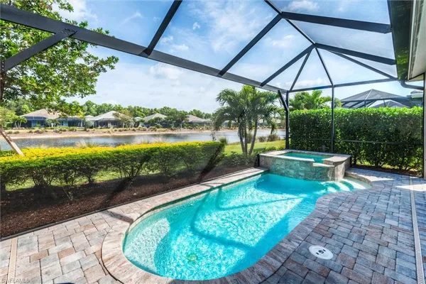 a view of a swimming pool with a patio and a garden