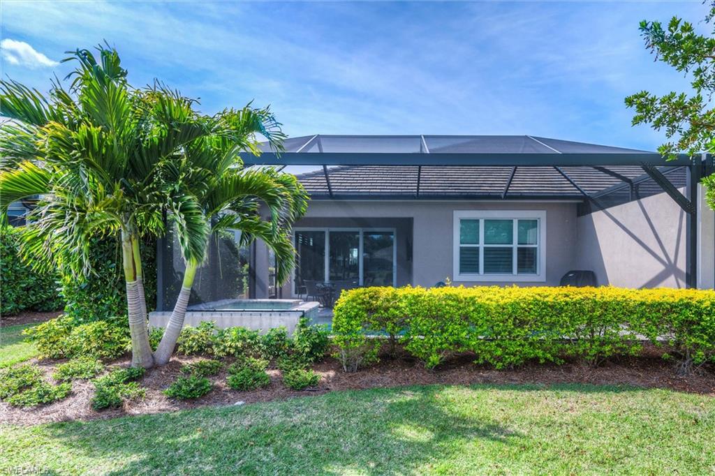 5743 Highbourne Drive Naples, FL 34113 - Photo 16 of 27 a front view of a house with a garden
