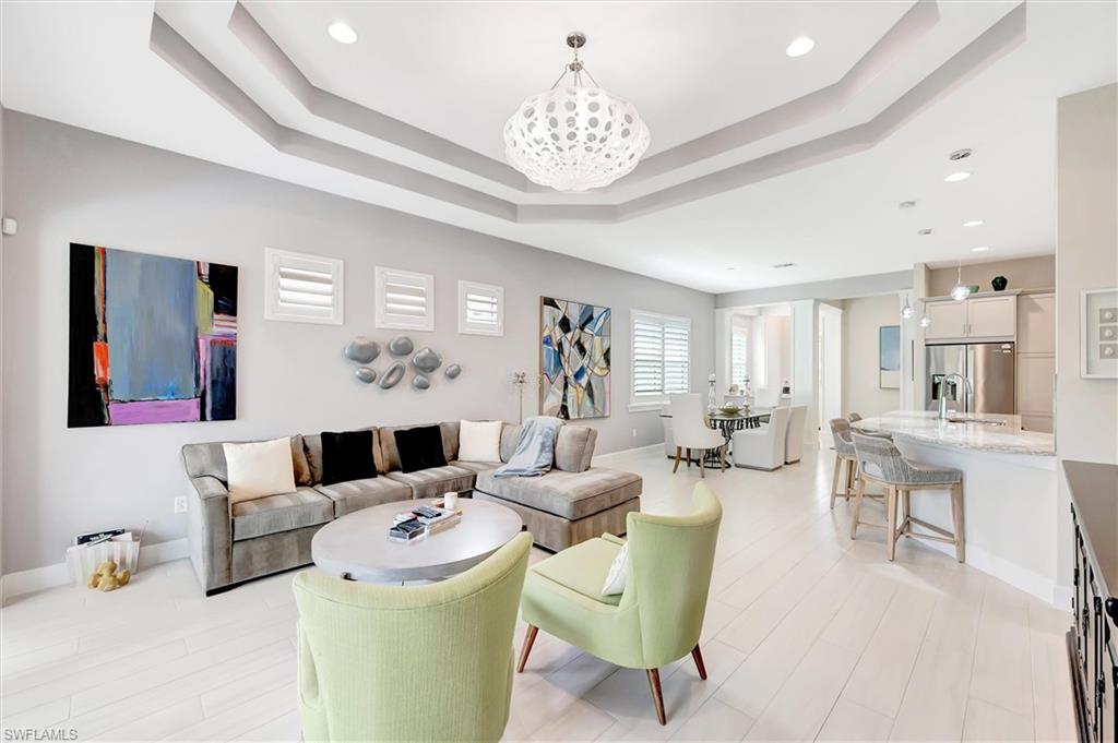 5743 Highbourne Drive Naples, FL 34113 - Photo 17 of 27 a living room with furniture and a chandelier