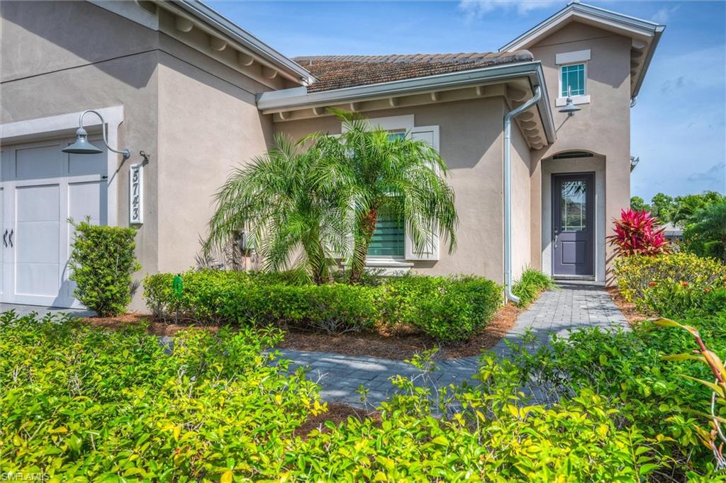 5743 Highbourne Drive Naples, FL 34113 - Photo 2 of 27 a front view of a house with garden