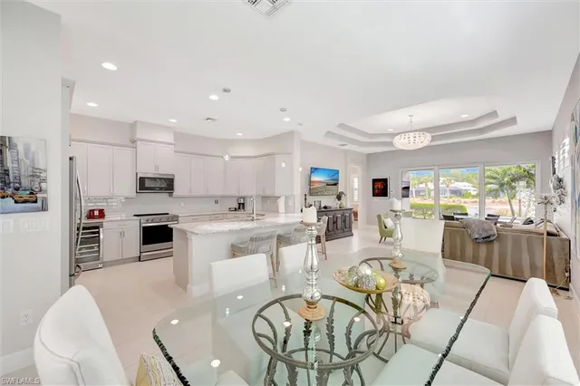 a large kitchen with a table and chairs