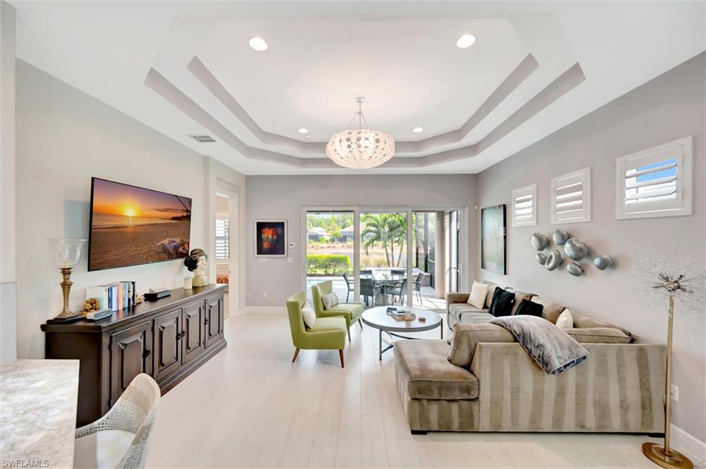 5743 Highbourne Drive Naples, FL 34113 - Photo 8 of 27 a living room with furniture and a flat screen tv