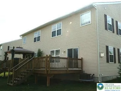 a view of a house with backyard and porch