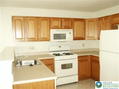 a kitchen with a stove a sink and a microwave