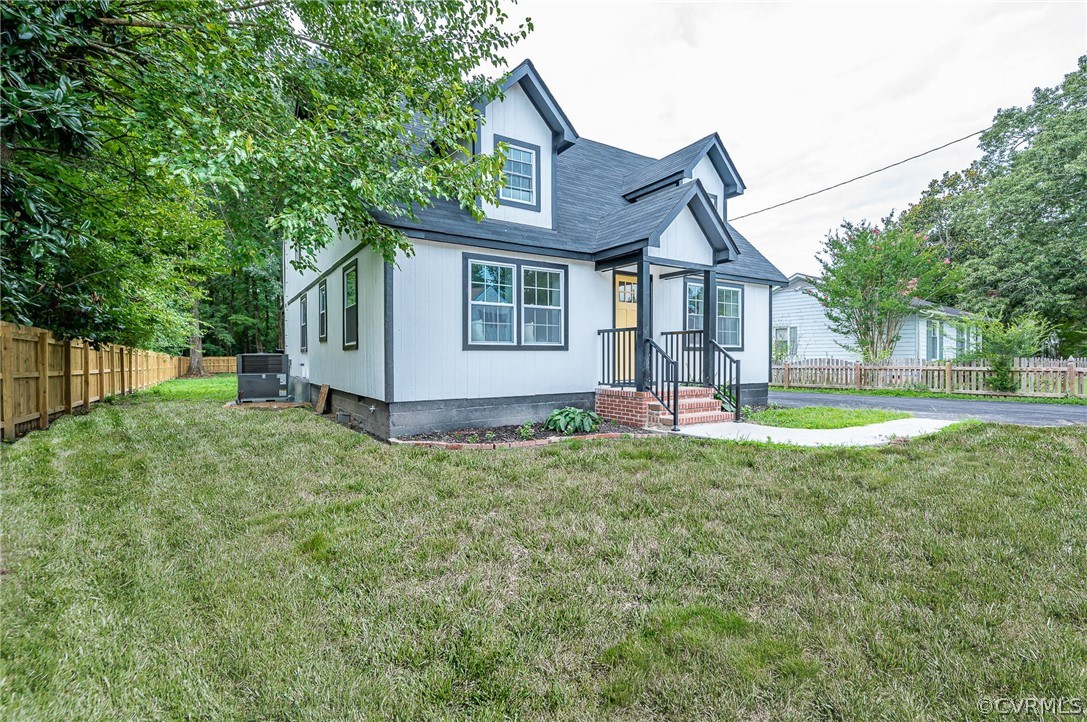 a view of a house with yard and a garden