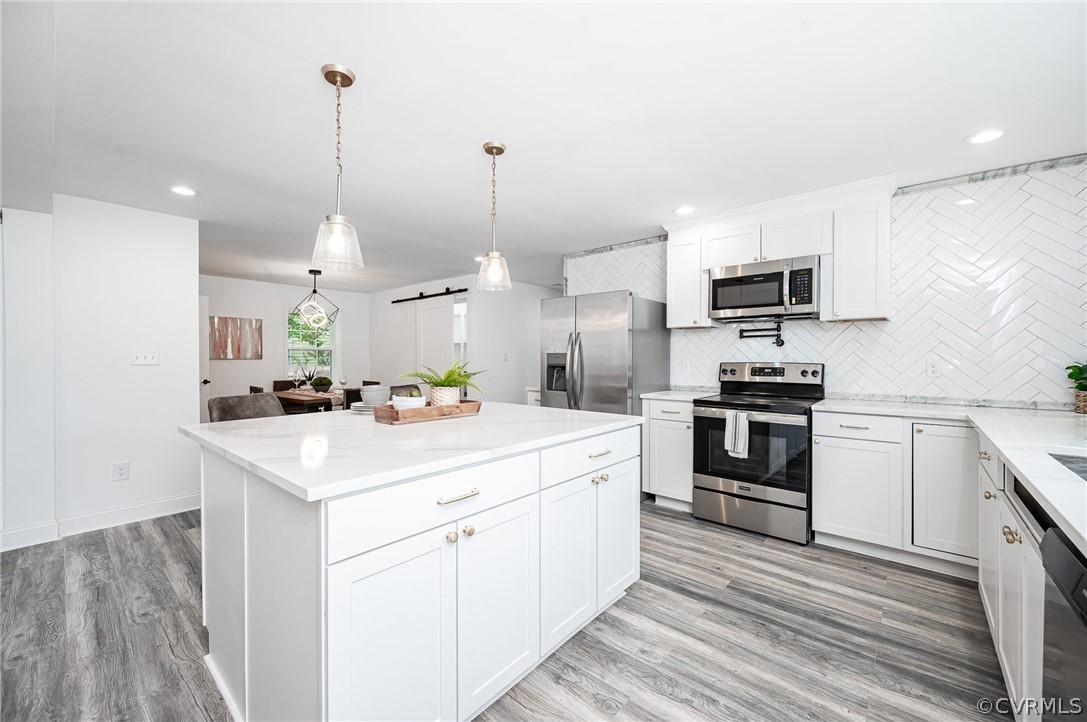 217 Henry Clay Road Ashland, VA 23005 - Photo 17 of 38 a kitchen with kitchen island a sink appliances and cabinets