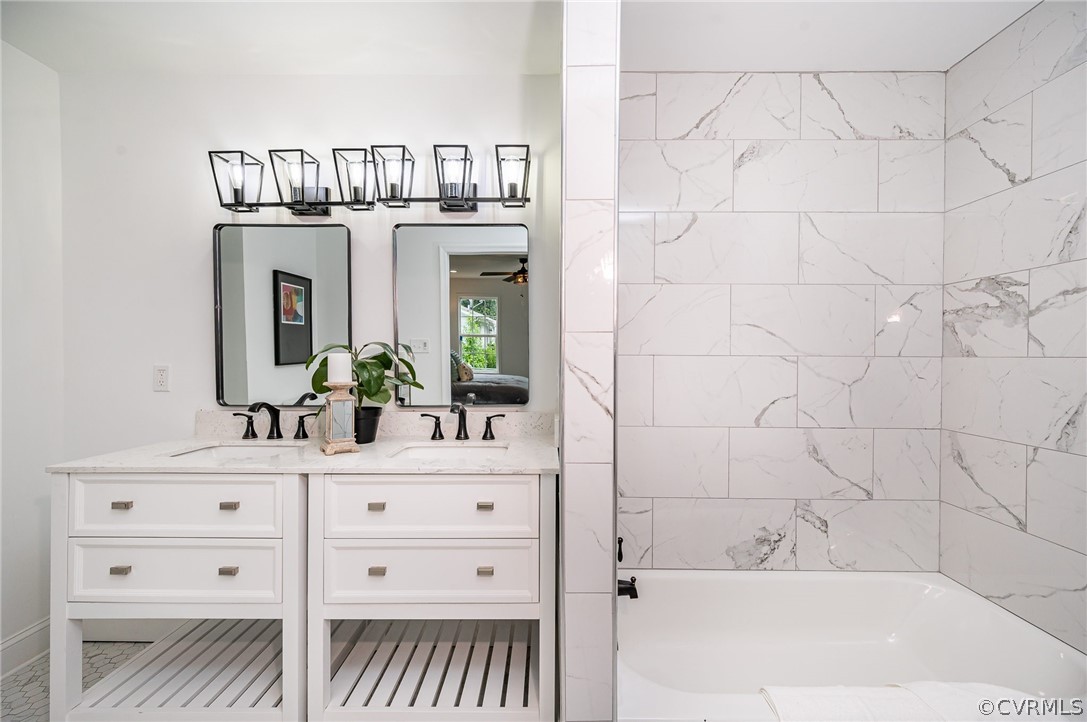 217 Henry Clay Road Ashland, VA 23005 - Photo 22 of 38 a bathroom with a bathtub a sink and a mirror