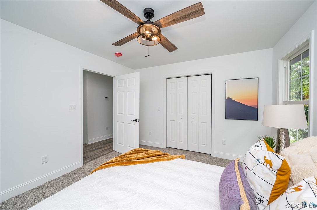 217 Henry Clay Road Ashland, VA 23005 - Photo 27 of 38 a bedroom with a bed and a chandelier
