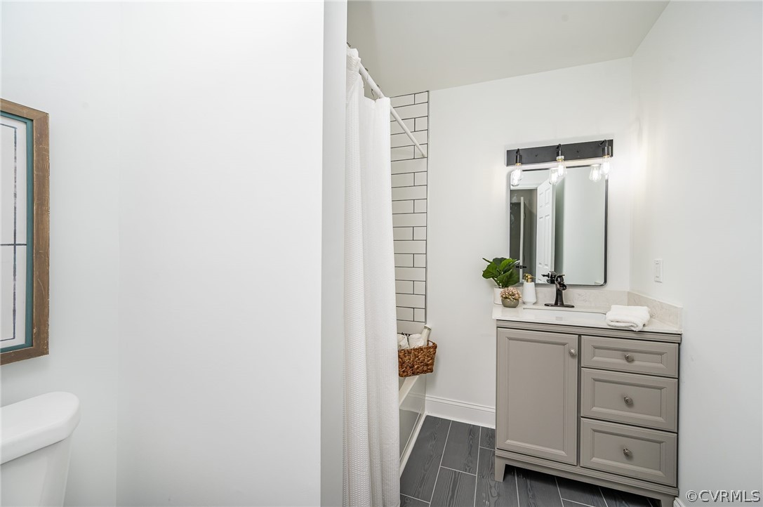 217 Henry Clay Road Ashland, VA 23005 - Photo 29 of 38 a bathroom with a sink a toilet and mirror