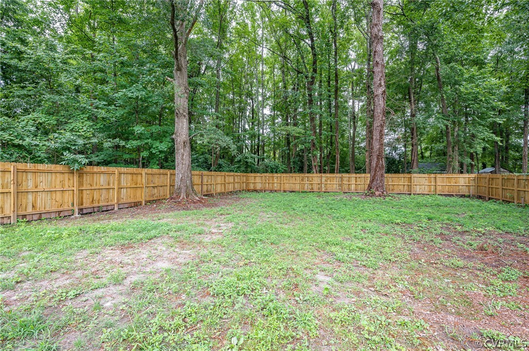 217 Henry Clay Road Ashland, VA 23005 - Photo 37 of 38 a view of backyard with green space and wooden fence