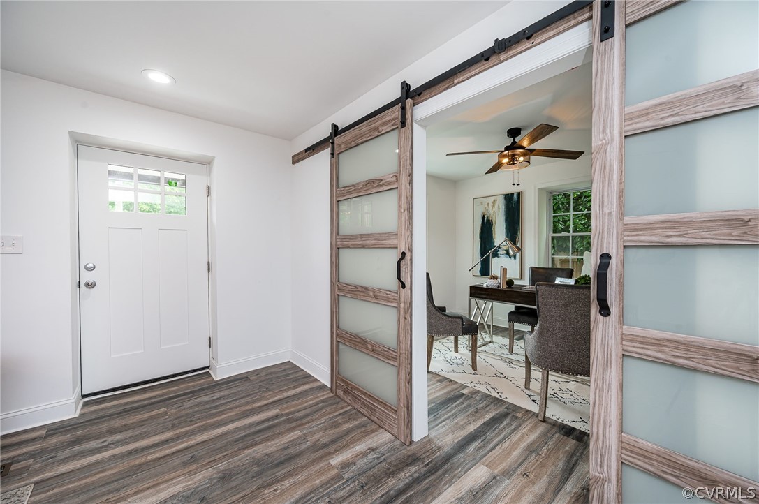 217 Henry Clay Road Ashland, VA 23005 - Photo 4 of 38 a view of a hallway to a livingroom with wooden floor and furniture