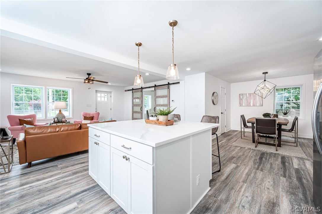 217 Henry Clay Road Ashland, VA 23005 - Photo 9 of 38 a kitchen that has a sink a stove and chairs with wooden floor