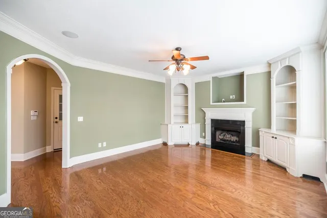a view of an empty room with a fireplace and a window