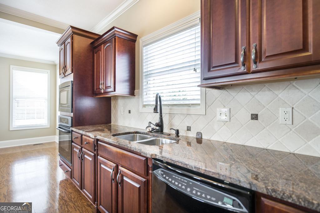 202 Avondale Circle Warner Robins, GA 31088 - Photo 17 of 40 a kitchen with stainless steel appliances granite countertop a sink a stove and a microwave