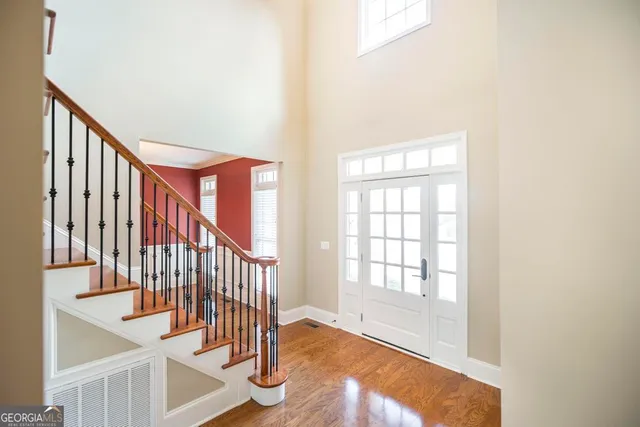 a view of an entryway with wooden floor