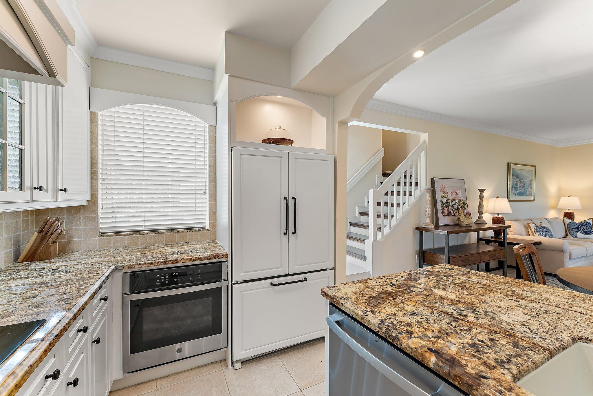 2905 Fairway Drive North Jupiter, FL 33477 - Photo 12 of 65 a kitchen with stainless steel appliances granite countertop a sink stove and refrigerator